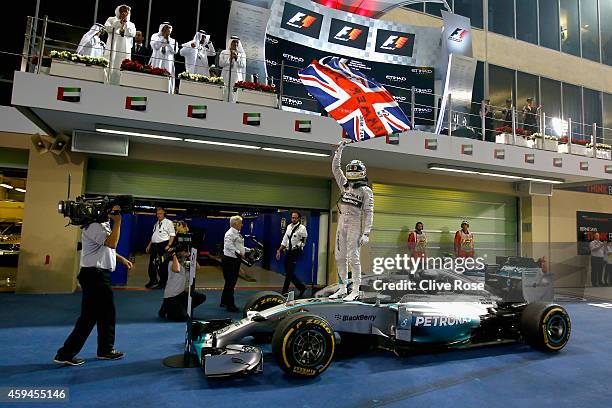 Lewis Hamilton of Great Britain and Mercedes GP celebrates in Parc Ferme after winning the World Championship and the Abu Dhabi Formula One Grand...