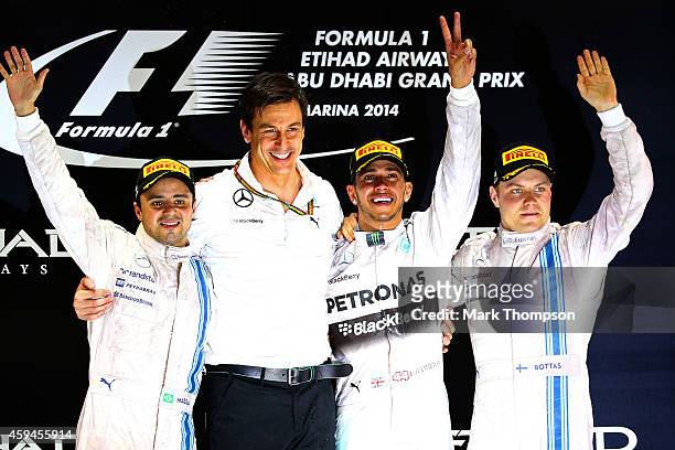 Lewis Hamilton of Great Britain and Mercedes GP celebrates on the podium next to Mercedes GP Executive Director Toto Wolff, Felipe Massa of Brazil...
