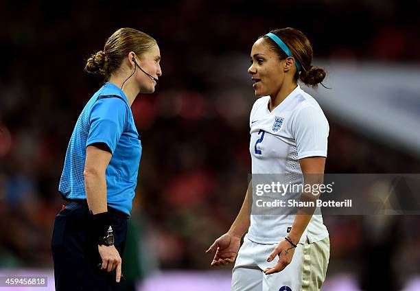 Alex Scott of England speaks with Referee Esther Staubli during the Women's International Friendly match between England and Germany at Wembley...