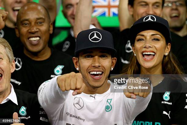 Lewis Hamilton of Great Britain and Mercedes GP celebrates with his team, father Anthony Hamilton and Nicole Scherzinger after winning the World...