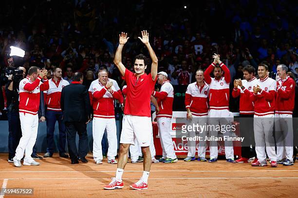 Roger Federer of Switzerland leads the celebrations after defeating Richard Gasquet of France as Stanislas Wawrinka of Switzerland , Marco...