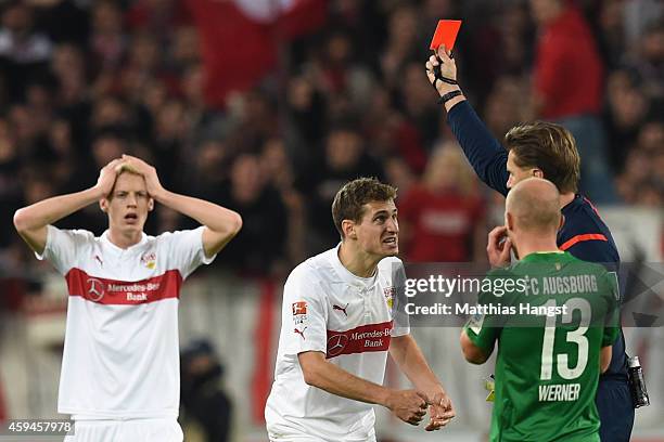 Daniel Schwaab of Stuttgart receives the red card from referee Thorsten Kinhoefer whilst his team mate Timo Baumgartl reacts during the Bundesliga...