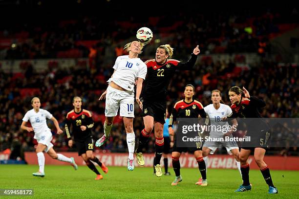 Toni Duggan of England wins a header under pressure from Luise Wensing of Germany during the Women's International Friendly match between England and...