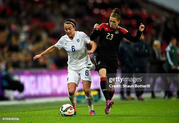 Lucy Bronze of England and Verena Faisst of Germany compete for the ball during the Women's International Friendly match between England and Germany...