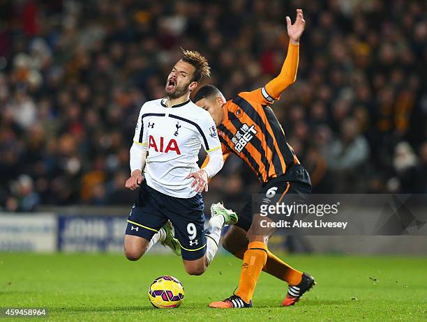 Roberto Soldado of Tottenham Hotspur is tackled by Curtis Davies of Hull City during the Barclays Premier League match between Hull City and...