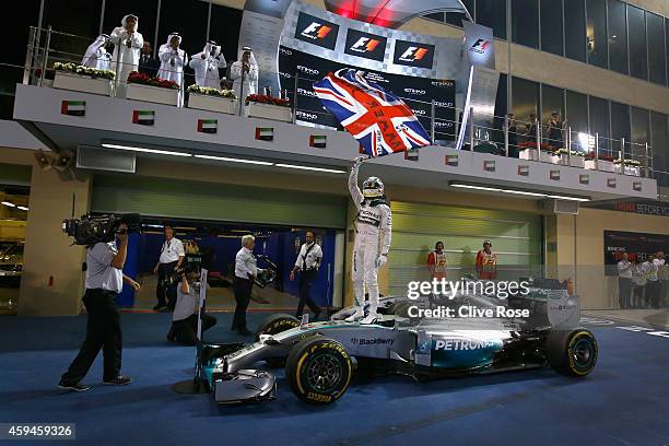 Lewis Hamilton of Great Britain and Mercedes GP celebrates in Parc Ferme after winning the World Championship and the Abu Dhabi Formula One Grand...