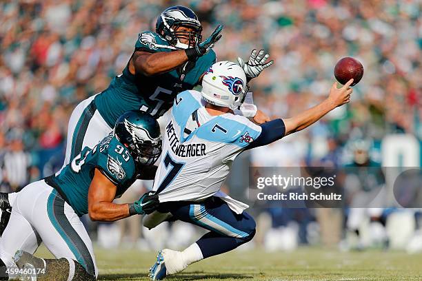 Quarterback Zach Mettenberger of the Tennessee Titans makes an incomplete pass against Mychal Kendricks and Brandon Graham of the Philadelphia Eagles...