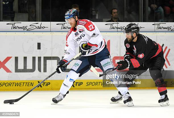 Barry Tallackson of the Eisbaeren Berlin and Jason Jaspers of the Thomas Sabo Ice Tigers Nuernberg in action during the game between Thomas Sabo Ice...