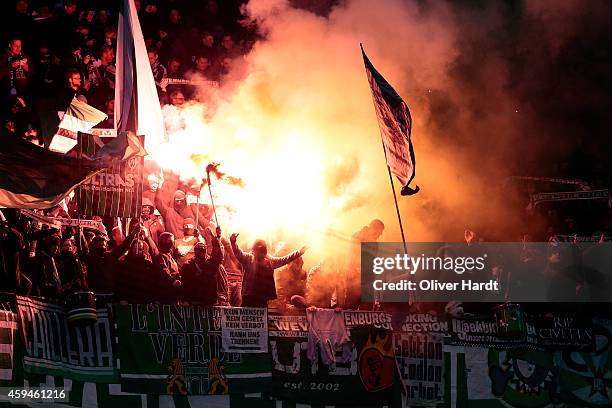 Supporters of Bremen burns firework during the First Bundesliga match between Hamburger SV and SV Werder Bremen at Imtech Arena on November 23, 2014...