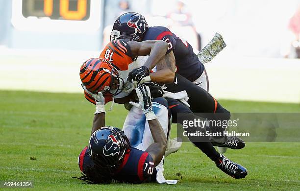 Green of the Cincinnati Bengals is tackled by Kendrick Lewis and Darryl Morris of the Houston Texans in the first half of their game at NRG Stadium...