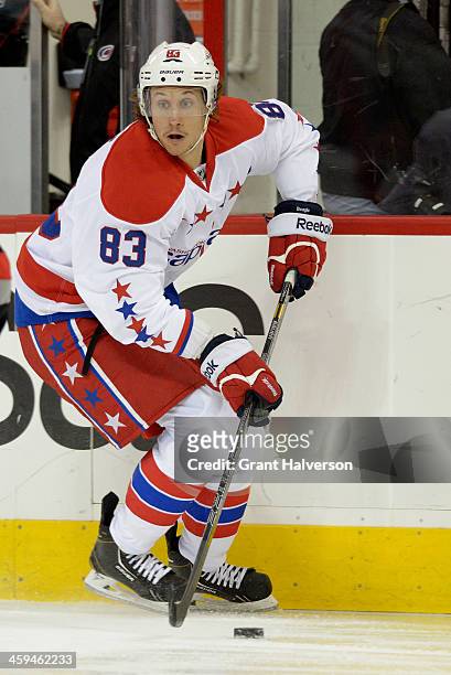 Jay Beagle of the Washington Capitals moves the puck against the Carolina Hurricanes during their game at PNC Arena on December 20, 2013 in Raleigh,...