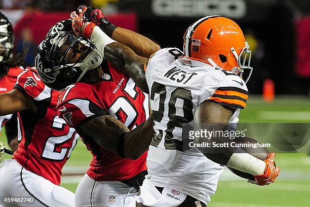 Robert McClain of the Atlanta Falcons is stiff armed by Terrance West of the Cleveland Browns in the first half at Georgia Dome on November 23, 2014...