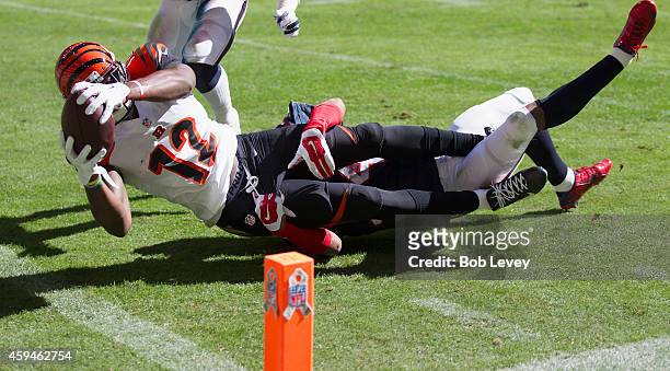 Mohamed Sanu of the Cincinnati Bengals scores in the first quarter as A.J. Bouye of the Houston Texans can't make the tackle at NRG Stadium on...