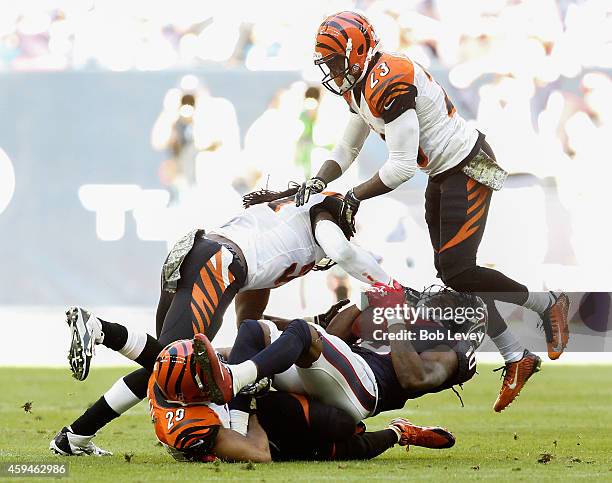 DeAndre Hopkins of the Houston Texans takes a hard hit as he is tackled by Leon Hall of the Cincinnati Bengals at NRG Stadium on November 23, 2014 in...