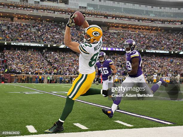 Jordy Nelson of the Green Bay Packers pulls in a pass that was later ruled incomplete while Xavier Rhodes and Robert Blanton of the Minnesota Vikings...