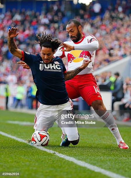 Thierry Henry of New York Red Bulls knocks Jermaine Jones of New England Revolution off the ball the during the Eastern Conference Final - Leg 1 at...