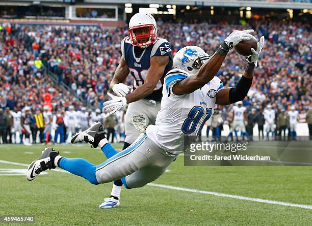 Calvin Johnson of the Detroit Lions makes a diving catch for a first down as Brandon Browner of the New England Patriots defends during the third...