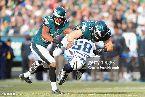 Nate Washington of the Tennessee Titans is tackled by Casey Matthews and Bradley Fletcher of the Philadelphia Eagles in the second quarter of the...