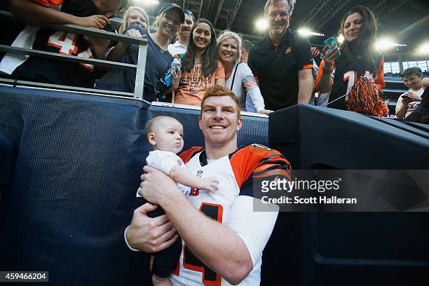 Andy Dalton of the Cincinnati Bengals poses with his son Noah in of his family and fans in the stands after the Bengals defeated the Houston Texans...
