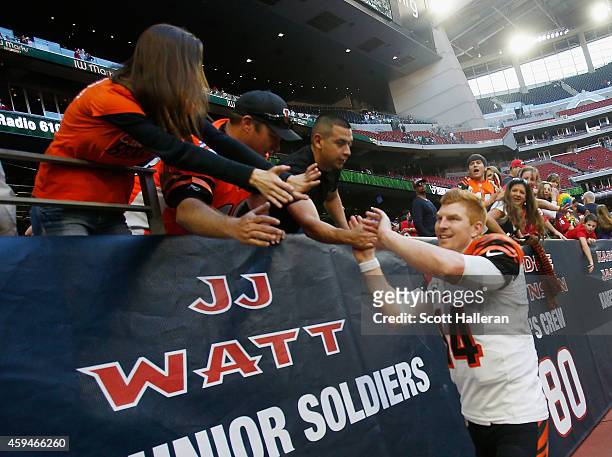Andy Dalton of the Cincinnati Bengals celebrates with fans in the stands after the Bengals defeated the Houston Texans 22-13 at NRG Stadium on...