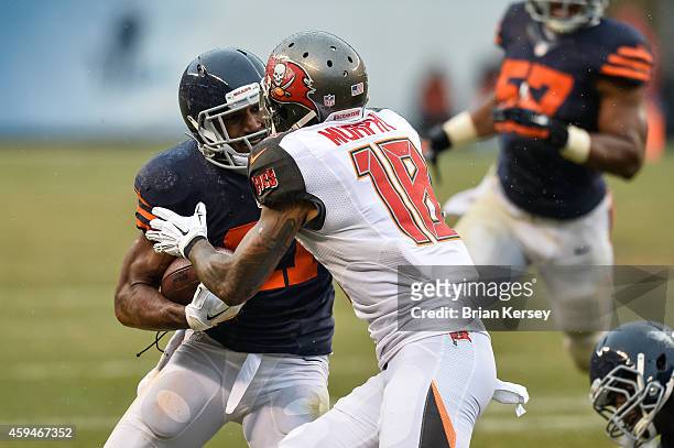 Strong safety Ryan Mundy of the Chicago Bears carries the interception against wide receiver Louis Murphy of the Tampa Bay Buccaneers in the third...