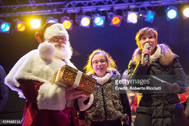 Santa Claus and Arlene Stuart with a Cash For Kids Charity girl during Light Night, the event that celebrates the inauguration of the Christmas Time...