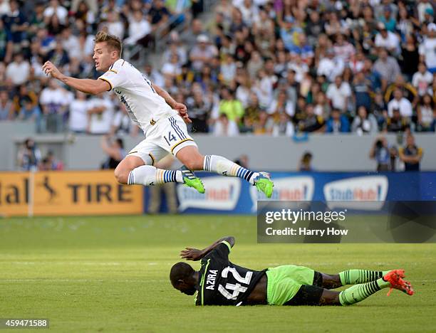 Robbie Rogers of Los Angeles Galaxy is tripped by Micheal Azira of Seattle Sounders FC during the Western Conference Final at StubHub Center on...