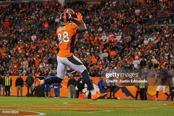 Wide receiver Demaryius Thomas of the Denver Broncos leaps to catch a 5-yard pass mid-stride in the end zone for a third quarter touchdown, his third...