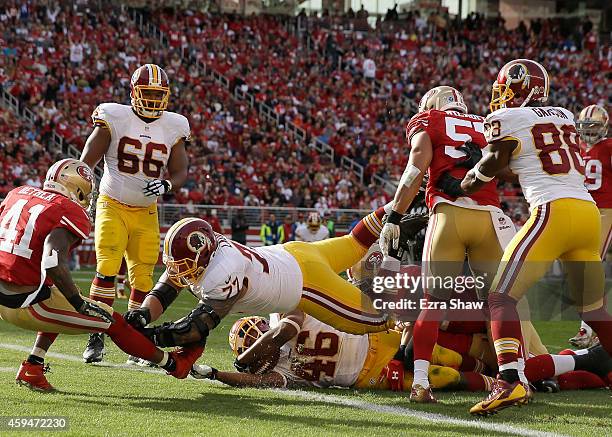 Alfred Morris of the Washington Redskins scores a touchdown in the second quarter under the block of Shawn Lauvao of the Washington Redskins against...