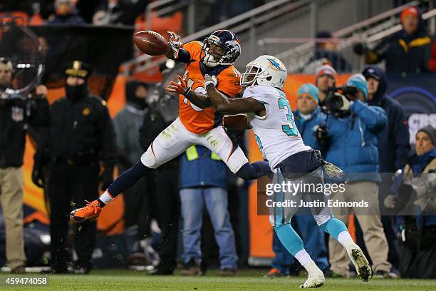 Wide receiver Emmanuel Sanders of the Denver Broncos has a fourth quarter reception for a first down under coverage by cornerback Walt Aikens of the...