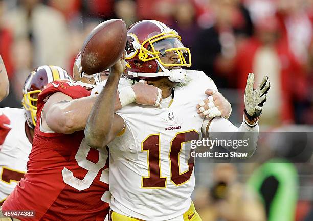 Justin Smith of the San Francisco 49ers forces a fumble from Robert Griffin III of the Washington Redskins in the fourth quarter at Levi's Stadium on...