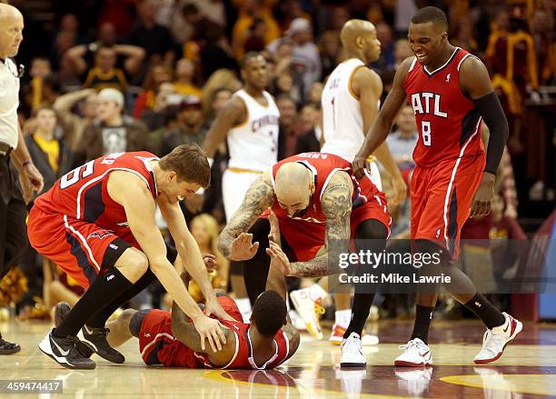 Jeff Teague of the Atlanta Hawks celebrates on the court with Kyle Korver, Pero Antic and Shelvin Mack after scoring the game winning basket in...