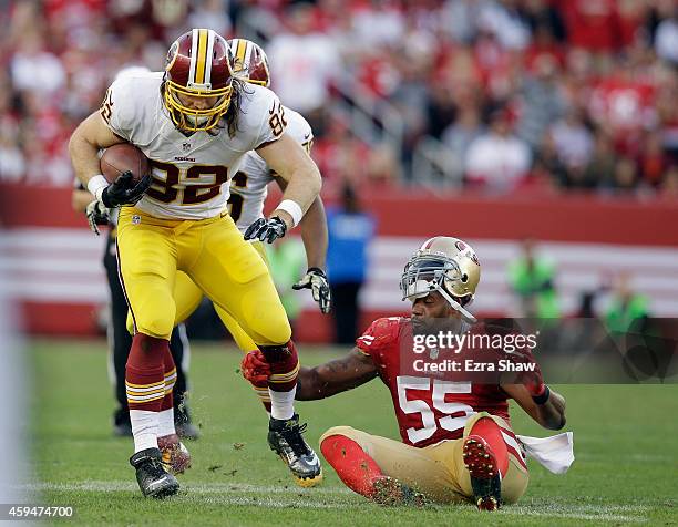 Ahmad Brooks of the San Francisco 49ers tries to tackled Logan Paulsen of the Washington Redskins at Levi's Stadium on November 23, 2014 in Santa...