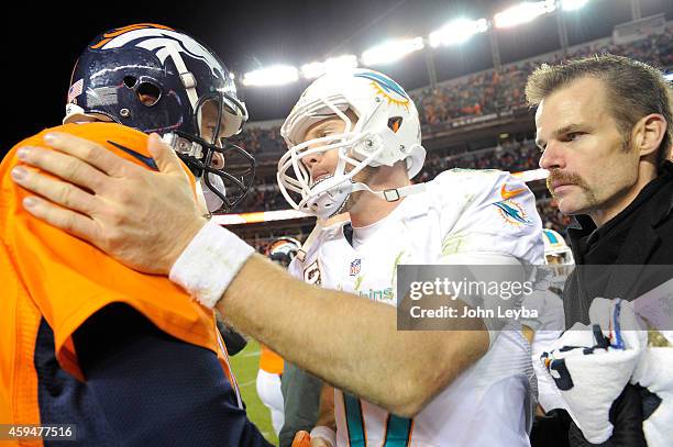 Peyton Manning of the Denver Broncos and Ryan Tannehill of the Miami Dolphins shake hands at the end f the game. The Denver Broncos played the Miami...