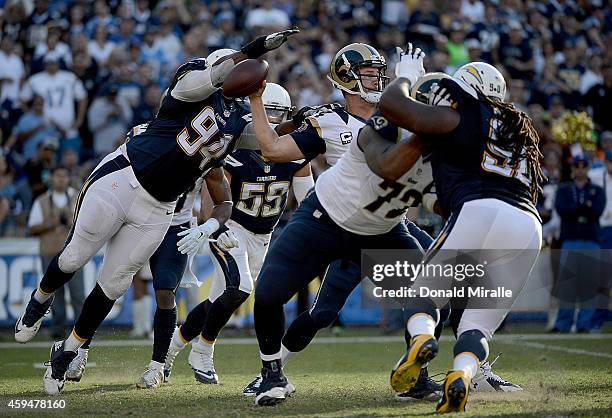 Quarterback Shaun Hill of the St. Louis Rams has the ball knocked out of his hand by Corey Liuget of the San Diego Chargers which resulted in a...