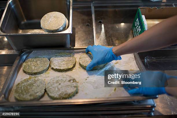 Chef prepares falafel burgers inside the kitchen at Beef & Liberty restaurant in Hong Kong, China, on Thursday, Sept. 4, 2014. Burger sales in Hong...