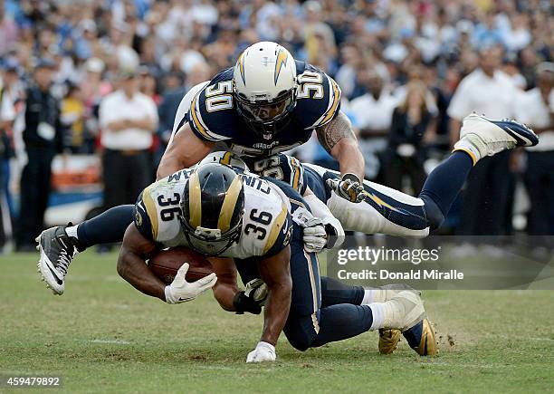 Benny Cunningham the St. Louis Rams is tackled by Manti Te'o and Andrew Gachkar of the San Diego Chargers during their NFL Game on November 23, 2014...