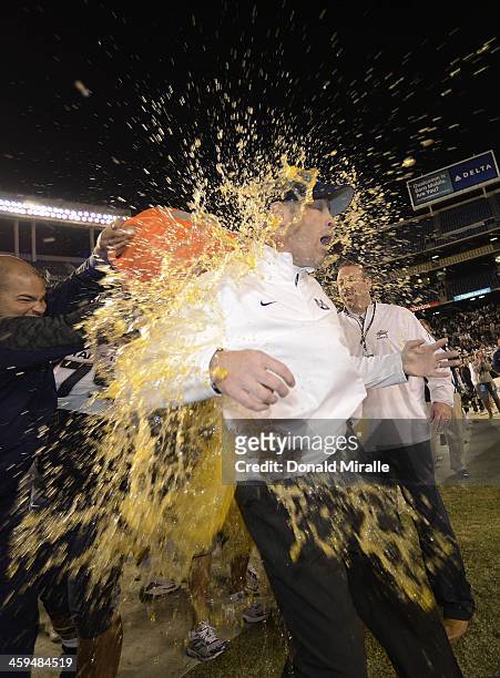 Head Coach Matt Wells of the Utah State Aggies gets the gatorade dump after his teams' 21-14 win over the Northern Illinois Huskies during the San...