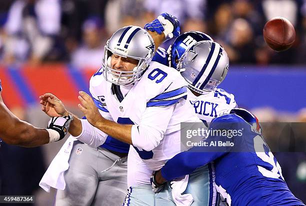 Tony Romo of the Dallas Cowboys is sacked by Mathias Kiwanuka of the New York Giants in the second quarter at MetLife Stadium on November 23, 2014 in...