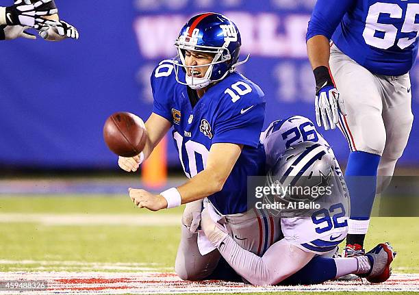 Jeremy Mincey of the Dallas Cowboys sacks Eli Manning of the New York Giants in the second quarter at MetLife Stadium on November 23, 2014 in East...