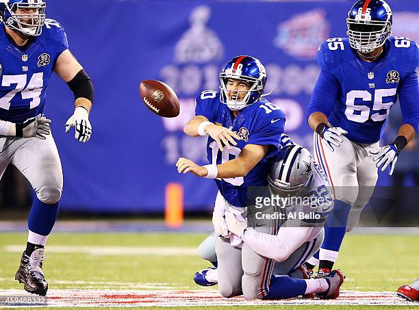 Jeremy Mincey of the Dallas Cowboys sacks Eli Manning of the New York Giants in the second quarter at MetLife Stadium on November 23, 2014 in East...