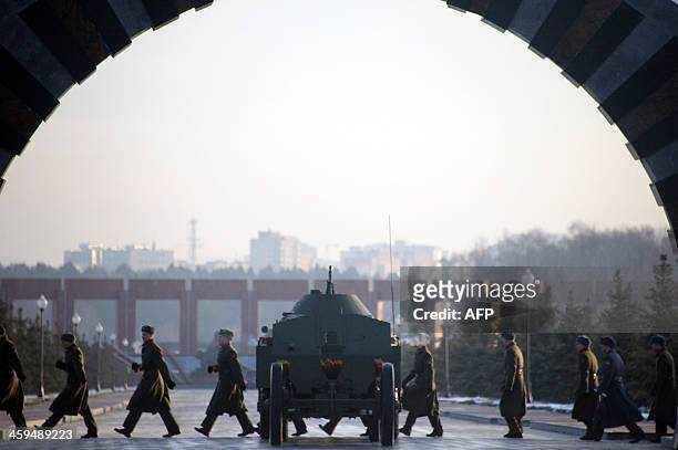 Russian soldiers walk past a gun carriage during the funeral ceremony of Mikhail Kalashnikov, the designer of the iconic AK-47 assault rifle that was...