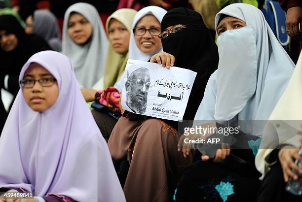 Malaysian Islamist holds a placard during a rally against the execution of top Bangladeshi Islamist leader Abdul Quader Molla in Kuala Lumpur on...
