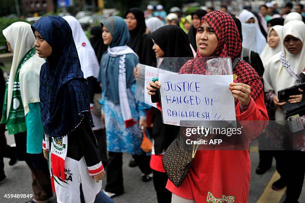 Malaysian Islamist holds a placard during a rally against the execution of top Bangladeshi Islamist leader Abdul Quader Molla in Kuala Lumpur on...