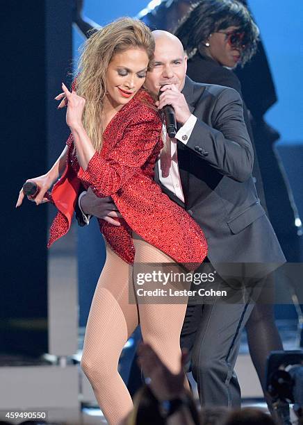 Entertainers Jennifer Lopez and Pitbull speak onstage at the 2014 American Music Awards at Nokia Theatre L.A. Live on November 23, 2014 in Los...