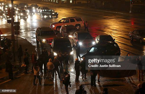 Demonstrators block an intersection while protesting the shooting death of 18-year-old Michael Brown on November 23, 2014 in St. Louis, Missouri....