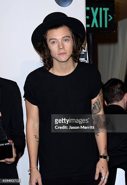 Singer Harry Styles of One Direction, winners of Artist of the Year, Favorite Pop/Rock Band/Duo/Group and Favorite Pop/Rock Album, poses in the press...