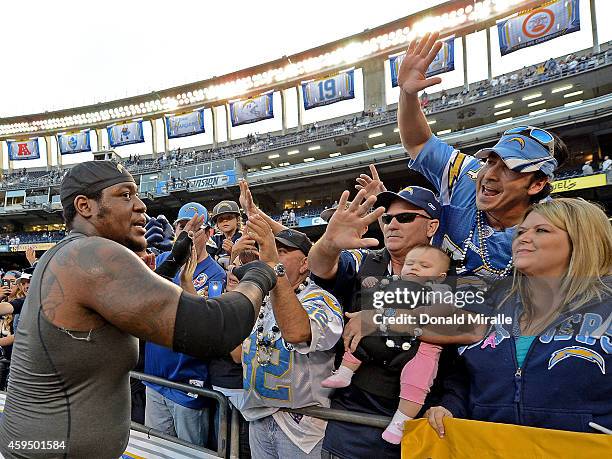 King Dunlap of the San Diego Chargers celebrates his team victory over the St. Louis Rams with fans during their NFL Game on November 23, 2014 in San...