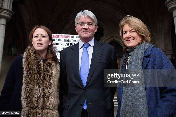 Andrew Mitchell, his wife Dr Sharon Bennett and a woman believed to be their daughter, arrive at the High Court on November 24, 2014 in London,...
