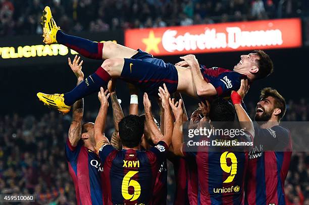 Lionel Messi of FC Barcelona celebrates with his teammates after scoring his team's fourth goal during the La Liga match between FC Barcelona and...